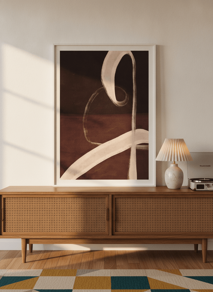 Modern wall art print standing on a sideboard in a mid-century bedroom