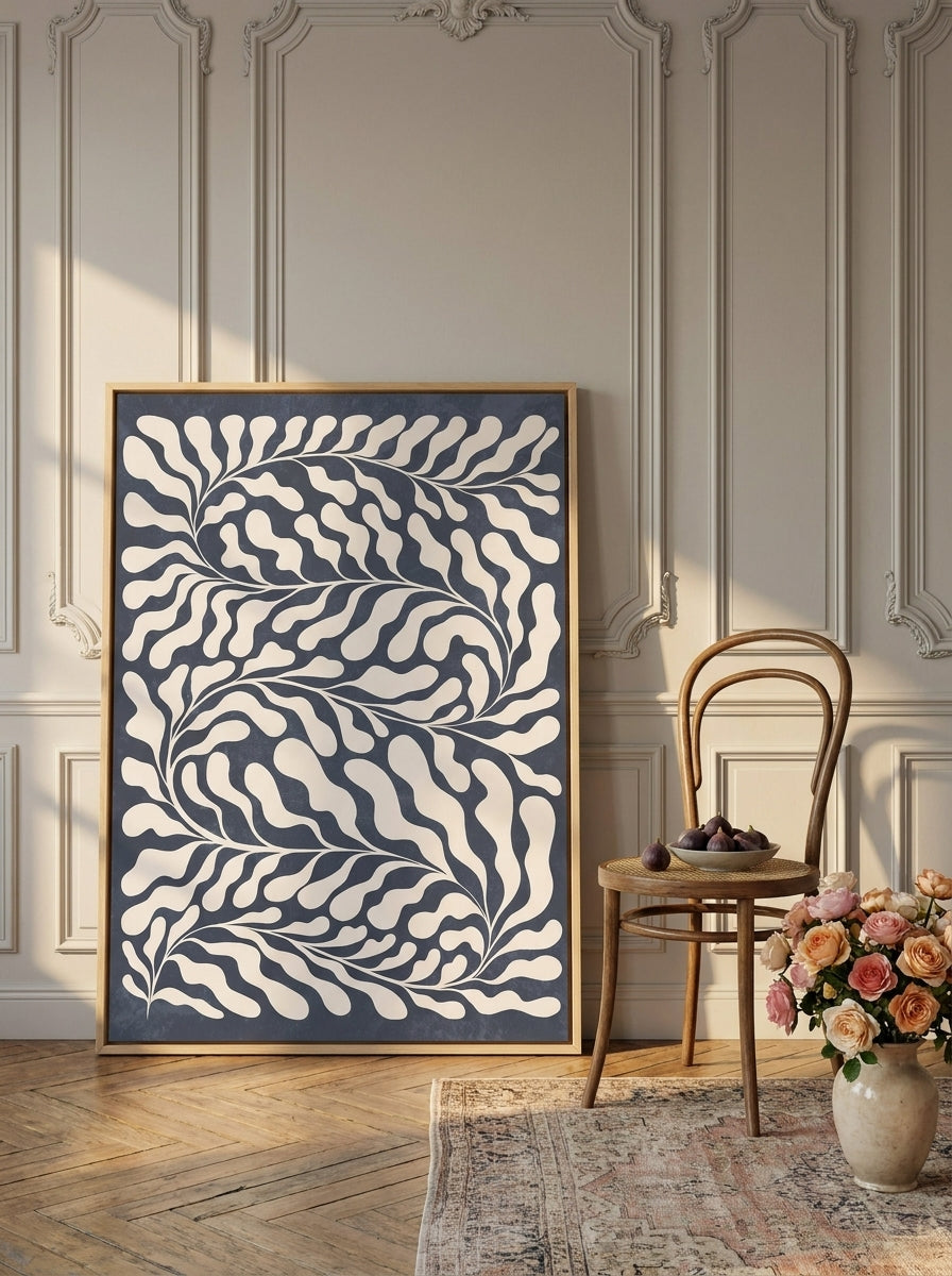 Oversized statement canvas wall art with a natural timber surround leaning against the wall in a Parisian dining room