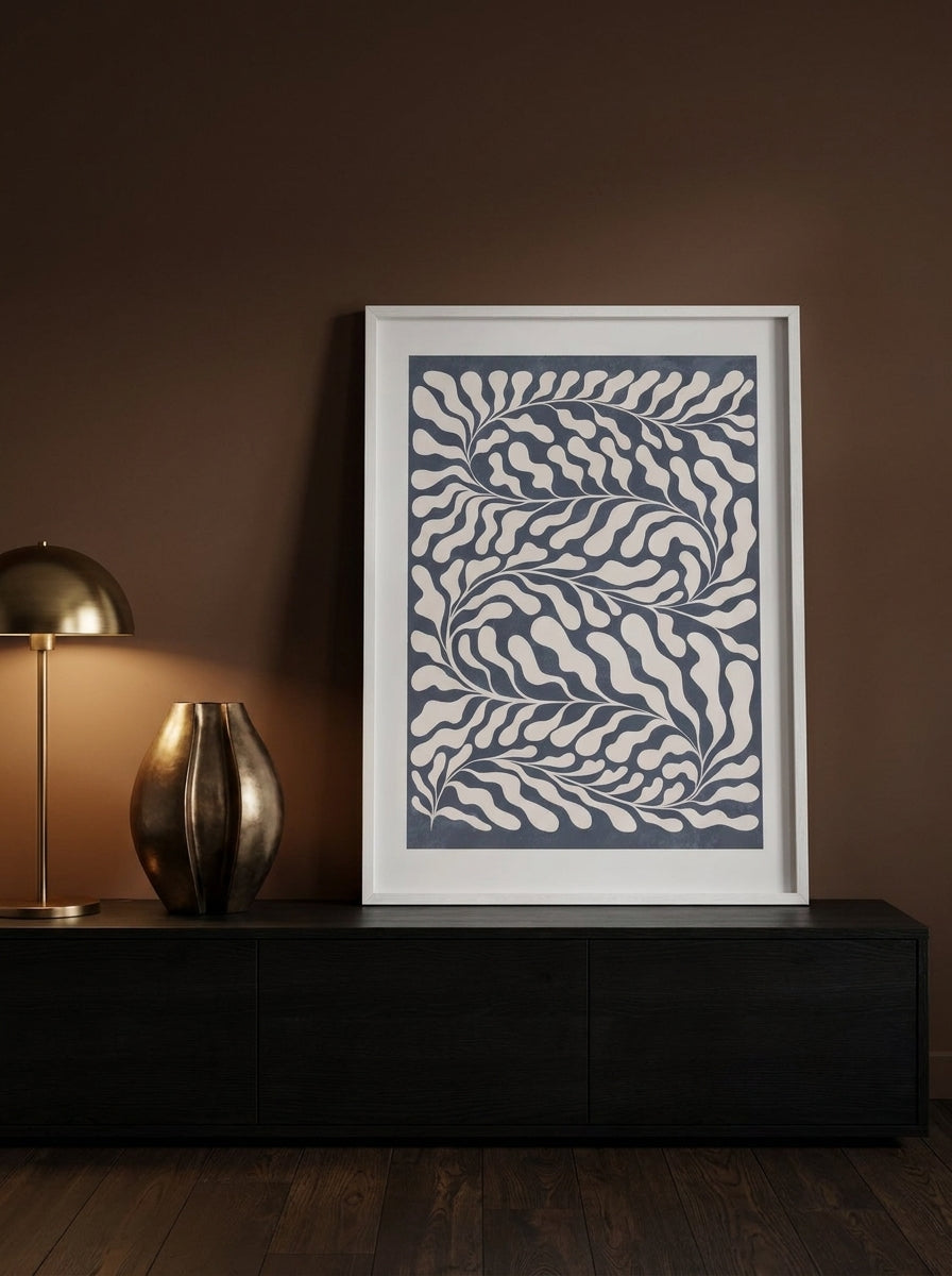 Modern wall art print standing on a console in a moody living room