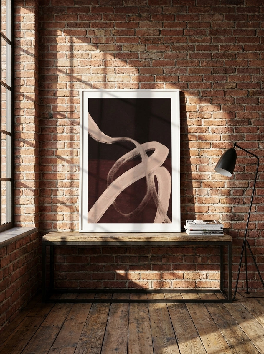 Modern wall art print standing on a console in an industrial loft bedroom