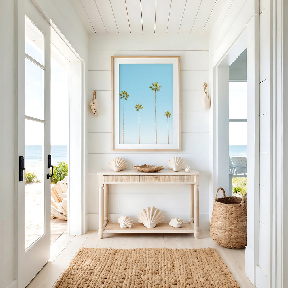 Nautical-themed interior with shell decor, a woven basket, and a beach scene on a white wall.