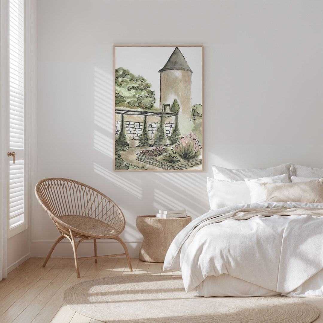 Bedroom with a painting of a garden scene on the wall, a wicker chair, and a bed.