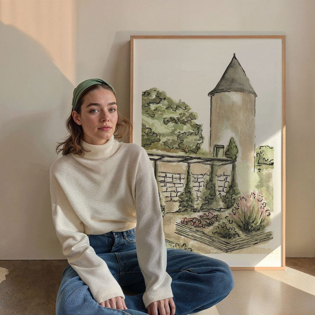 Woman sitting in front of watercolor painting of a tower and garden.