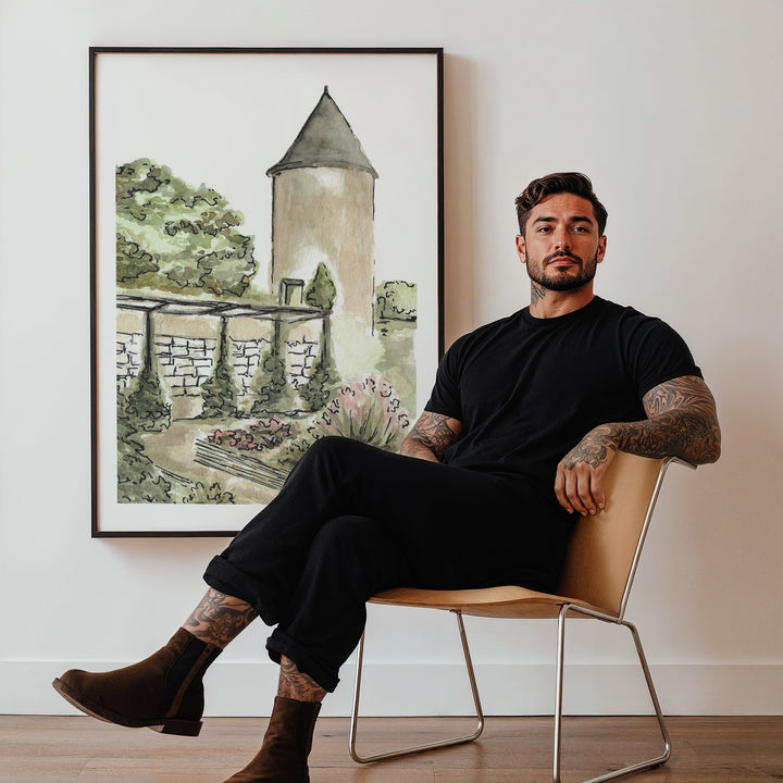 Man sitting on a chair in a room with a artwork of a garden scene on the wall.