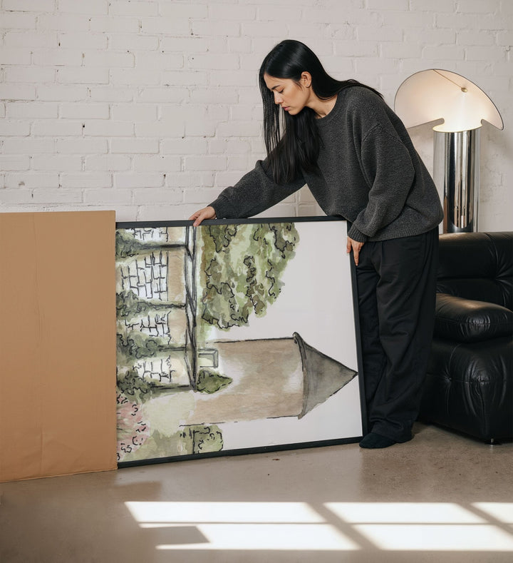 Woman standing next to a large artwork in a modern living room.