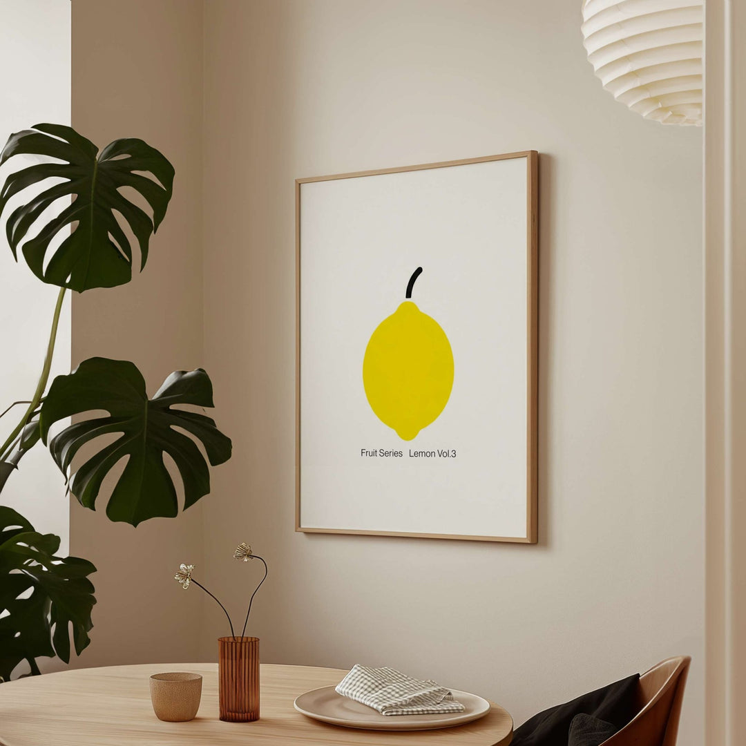 artwork of a lemon on a wall in a room with a plant and table.