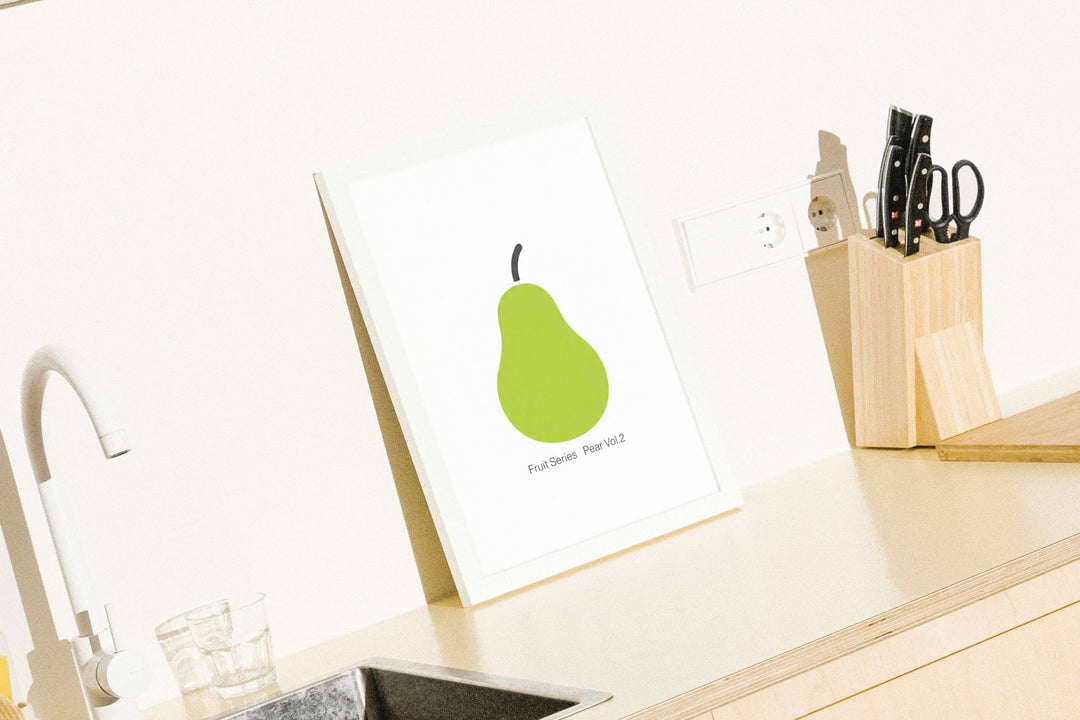 Kitchen counter with a pear illustration on a card and a knife set.