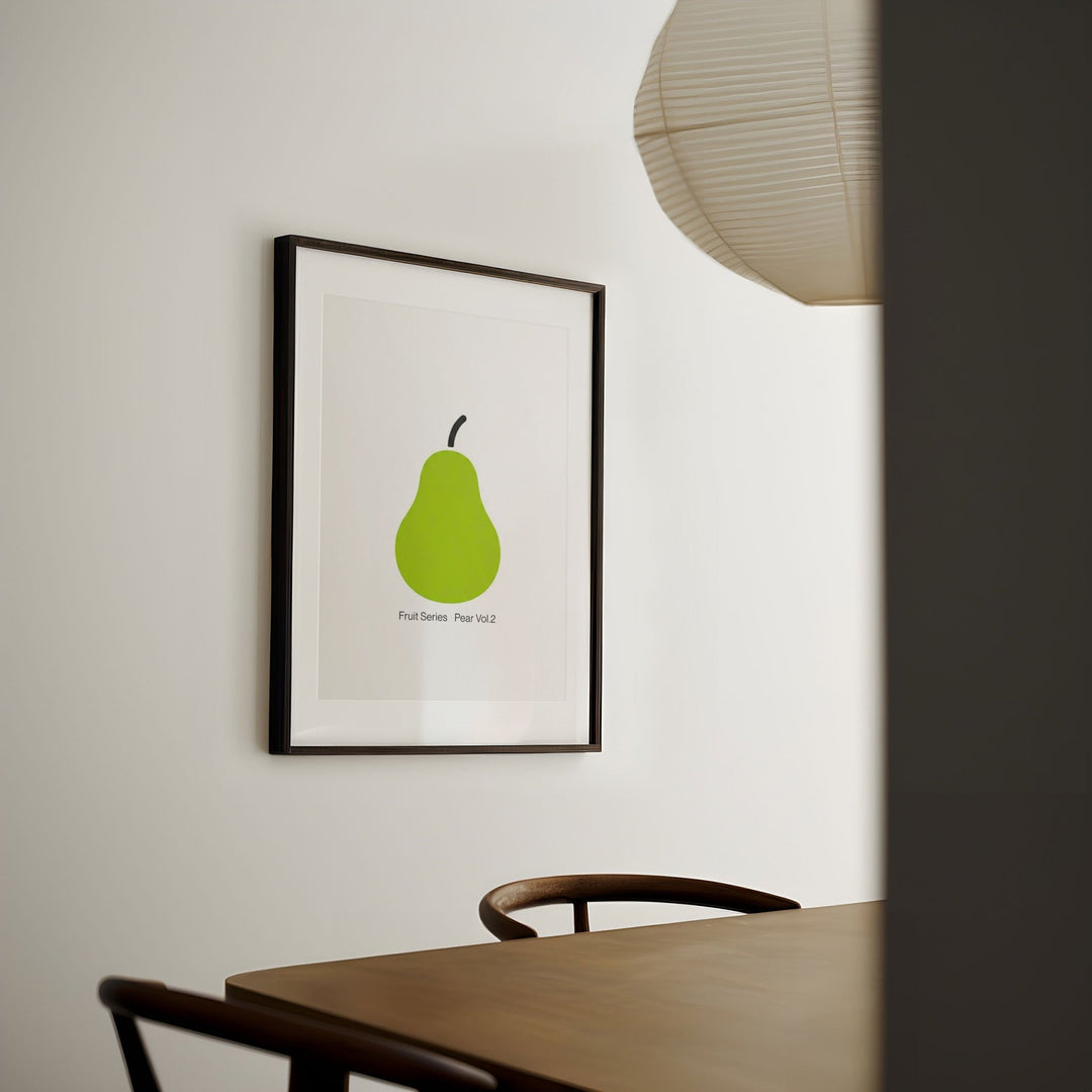 artwork of a green pear on a wall in a room with a table and chairs.