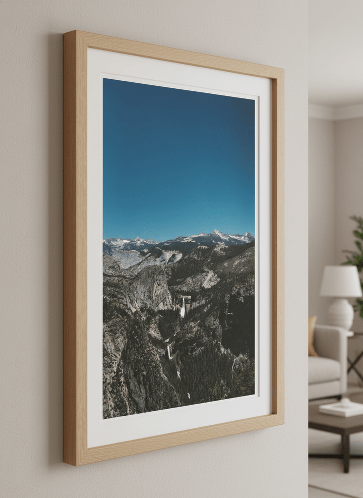 Modern wall art styled above a sofa in a neutral living room