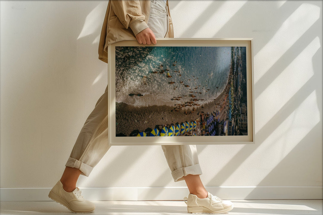 person walking holding photo of beach