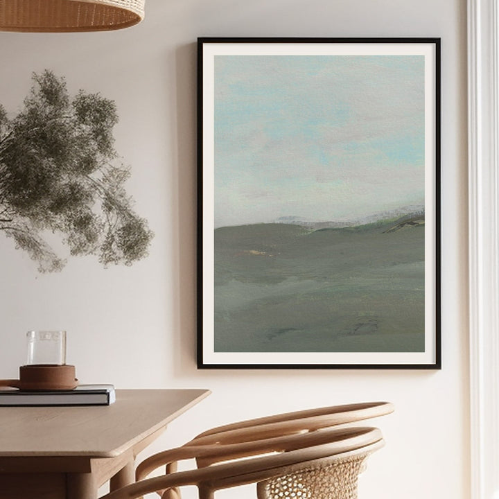 Landscape painting on a wall above a table and chair