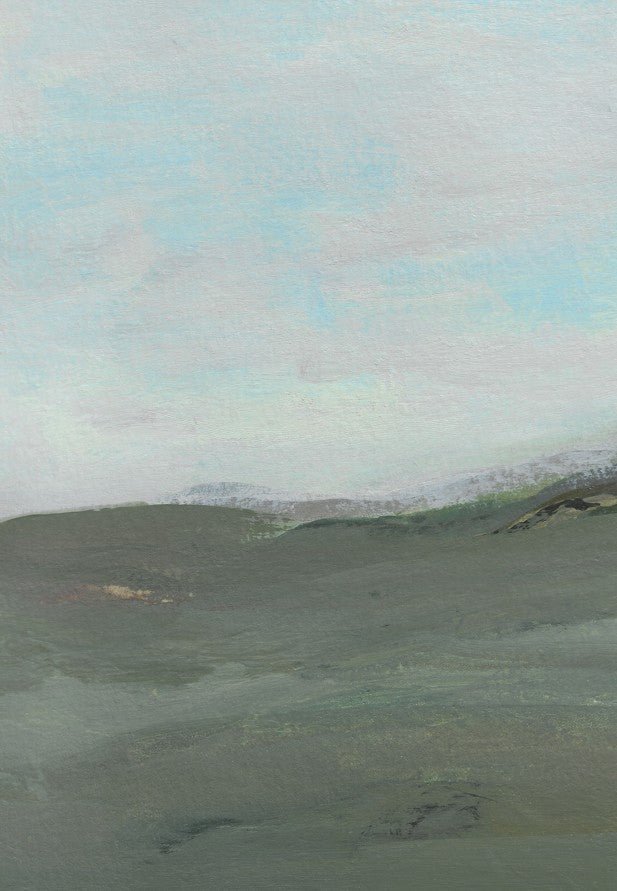 Hilly landscape with a cloudy sky framed