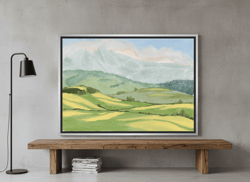 Canvas wall art with a silver leaf surround standing on a bench in an industrial loft bedroom