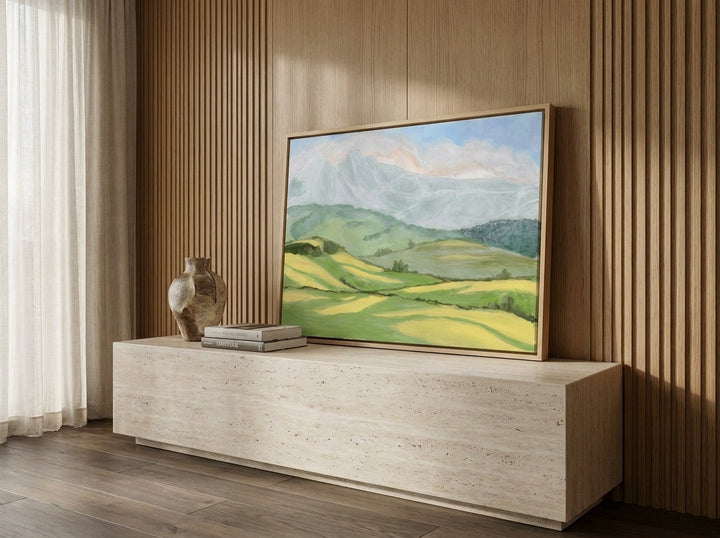Canvas wall art with a natural timber surround standing on a console in a luxe home office