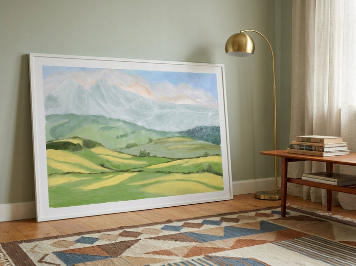 Oversized statement modern wall art print leaning against the wall in a mid-century living room
