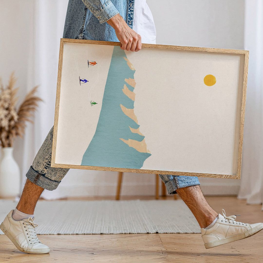 person walking holding an artwork of skiers