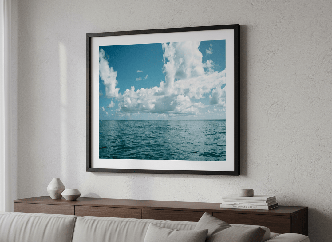 Modern wall art styled above a sofa in a neutral living room