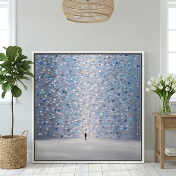 Canvas wall art with a white surround leaning against the wall in a bright Scandinavian home office