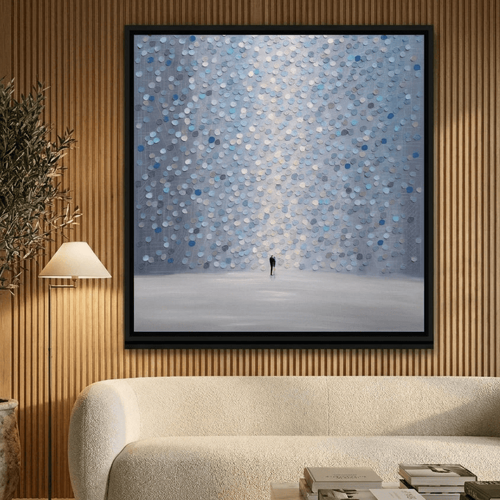 Oversized statement canvas wall art with a black surround styled on the wall in a luxe living room