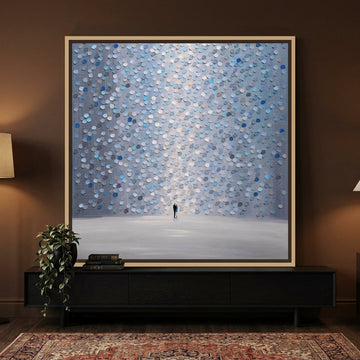 Canvas wall art with a natural timber surround standing on a console in a moody bedroom