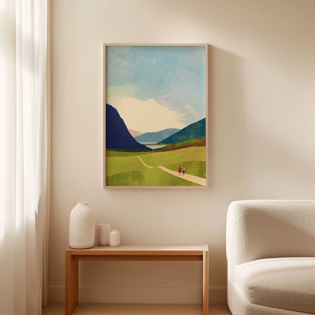 Landscape painting on a wall above a small table with decorative items, next to a sofa.
