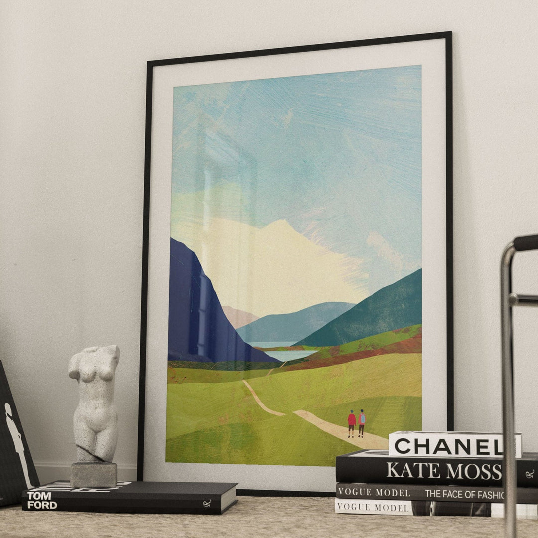Landscape print on a shelf with books and decor items in a room.