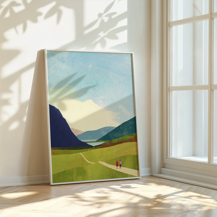 Artwork of a landscape with mountains and two figures on a path, placed in a bright room with sunlight filtering through.