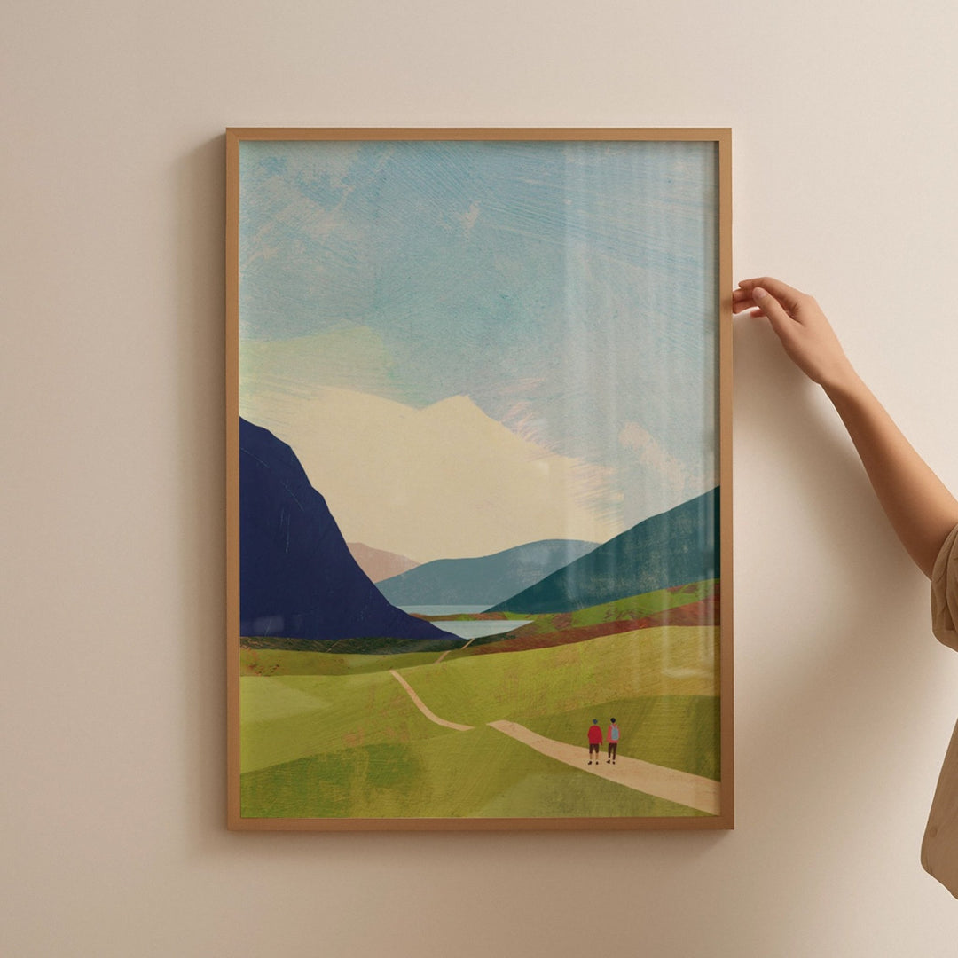 Artwork of a landscape with mountains and a path on a beige wall.