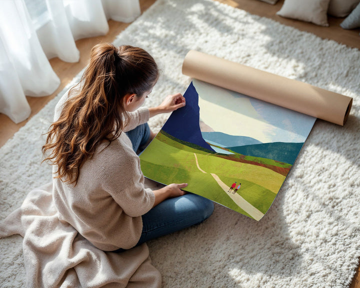 Woman unrolling a landscape painting on a carpeted floor