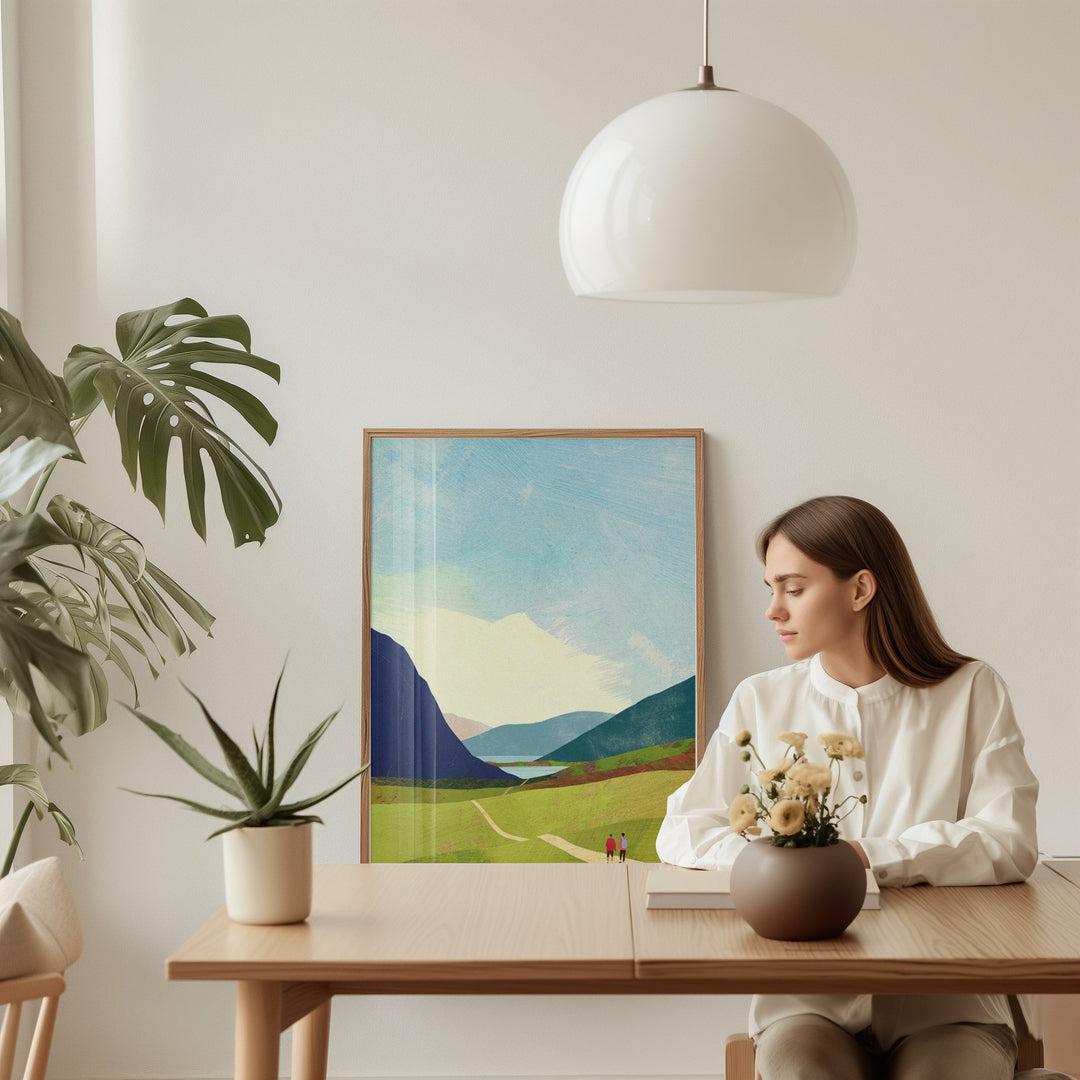 Woman sitting at a table with a scenic painting on the wall