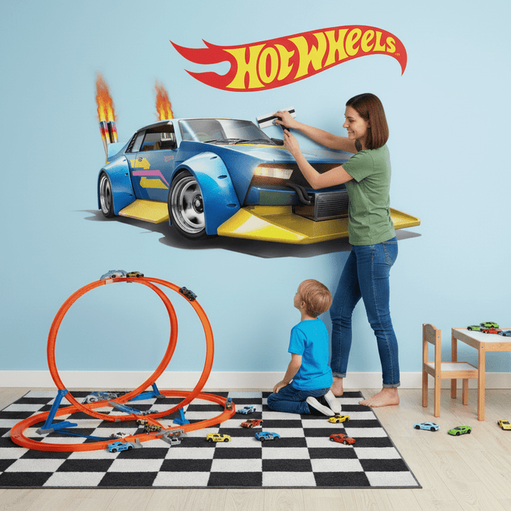 Woman and child playing with Hot Wheels toys in a room with a large Hot Wheels mural on the wall.