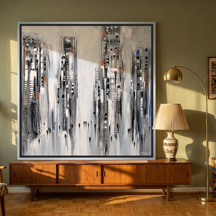 Canvas wall art with a silver leaf surround standing on a sideboard in a mid-century living room