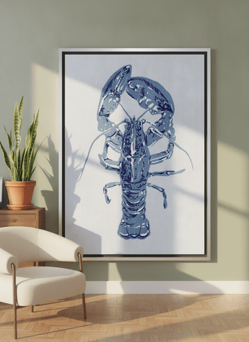 Oversized statement canvas wall art with a silver leaf surround leaning against the wall in a mid-century dining room