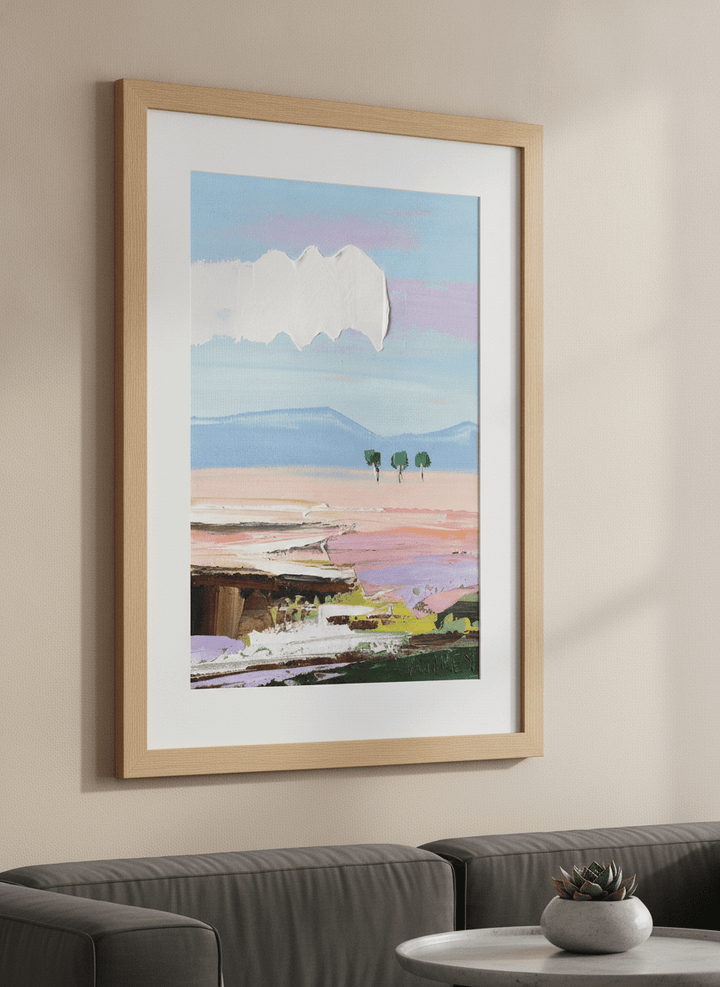 Modern wall art styled above a sofa in a neutral living room