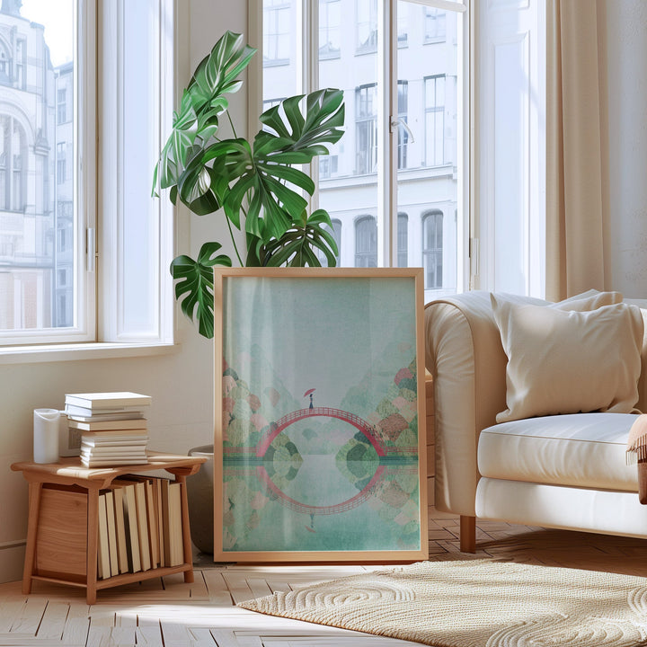 Living room with a artwork, plant, and books on a side table.