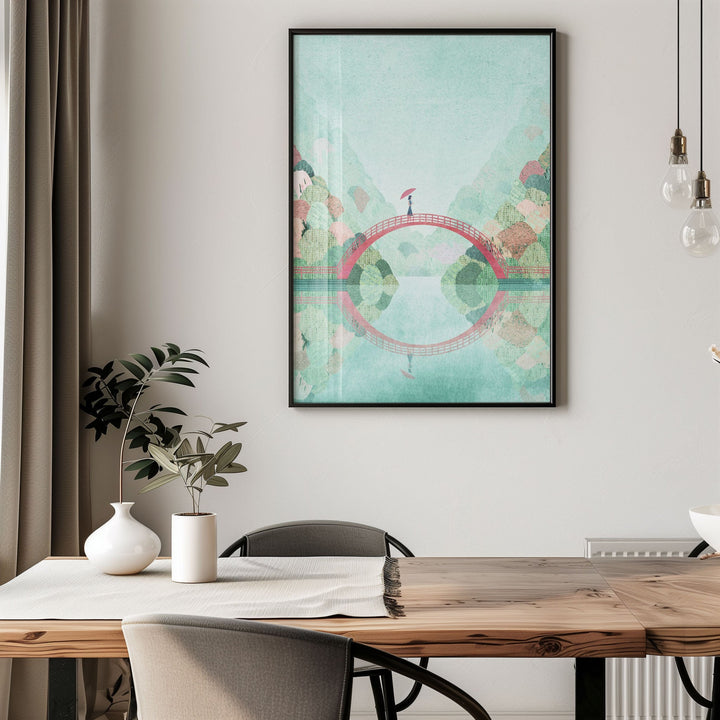 Artwork of a bridge over water on a wall above a dining table.