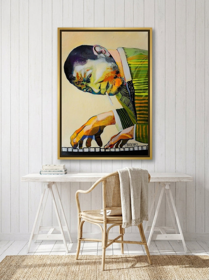 Canvas wall art with a gold leaf surround styled on the wall in a coastal home office