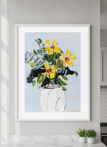 Artwork styled on the wall of a bright modern kitchen