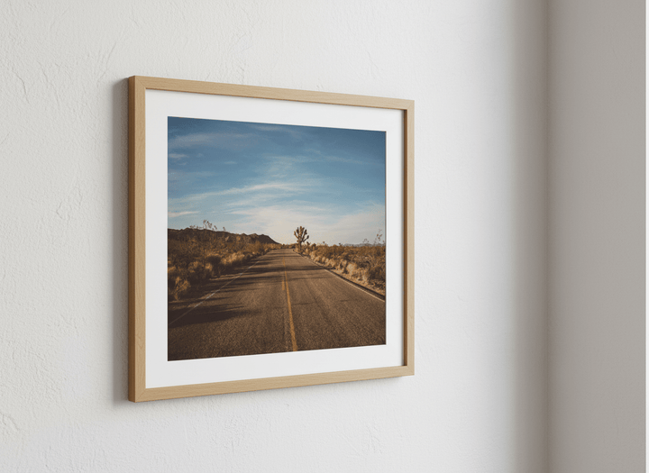 Modern wall art styled above a sofa in a neutral living room