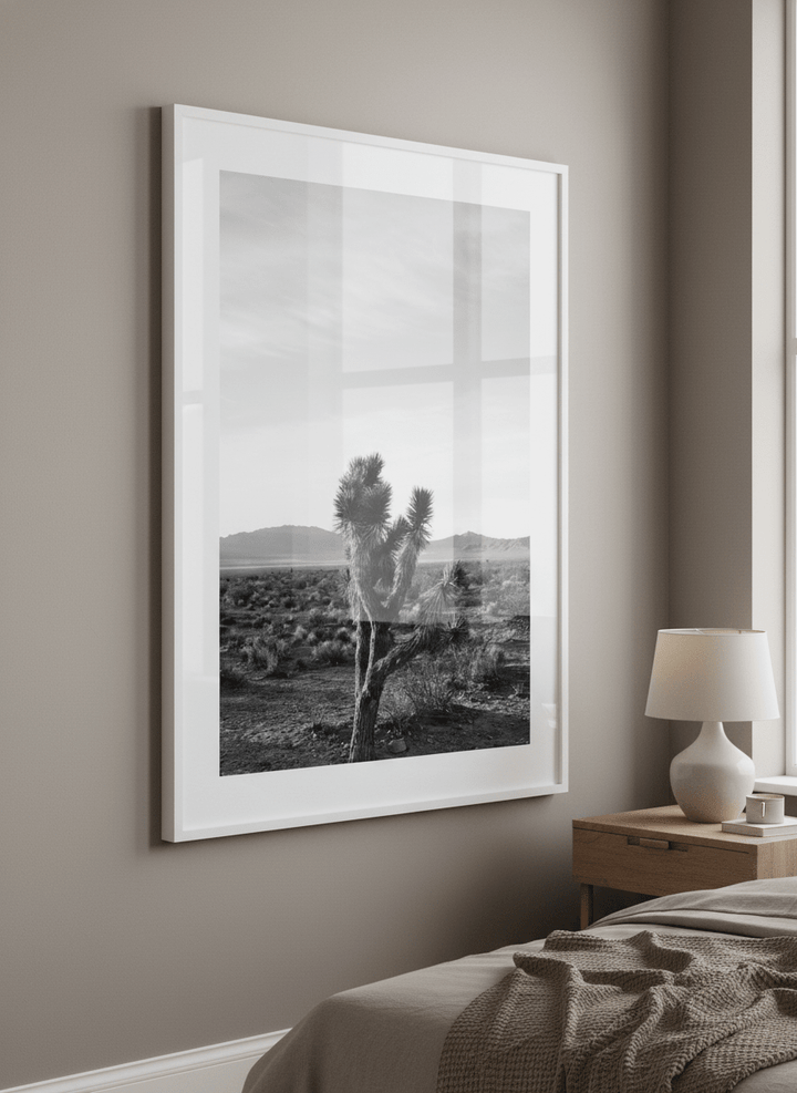 Minimalist artwork displayed in a calm, light-filled bedroom interior