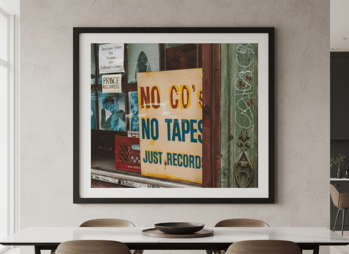 Wall art styled above a dining table in a contemporary home