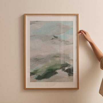 Abstract art piece on a beige wall with a hand.