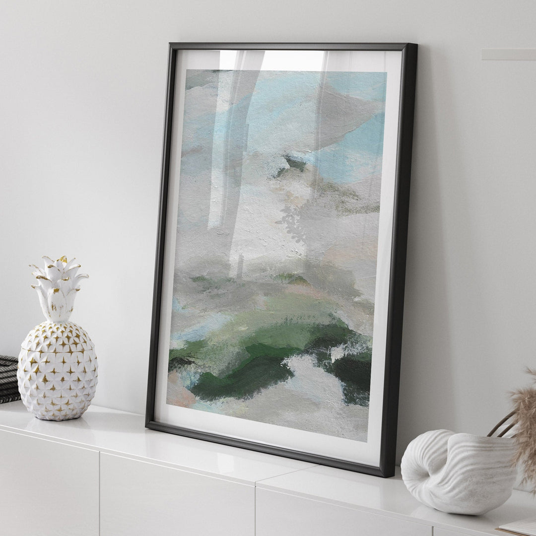 abstract art piece on a white wall with decorative items below.