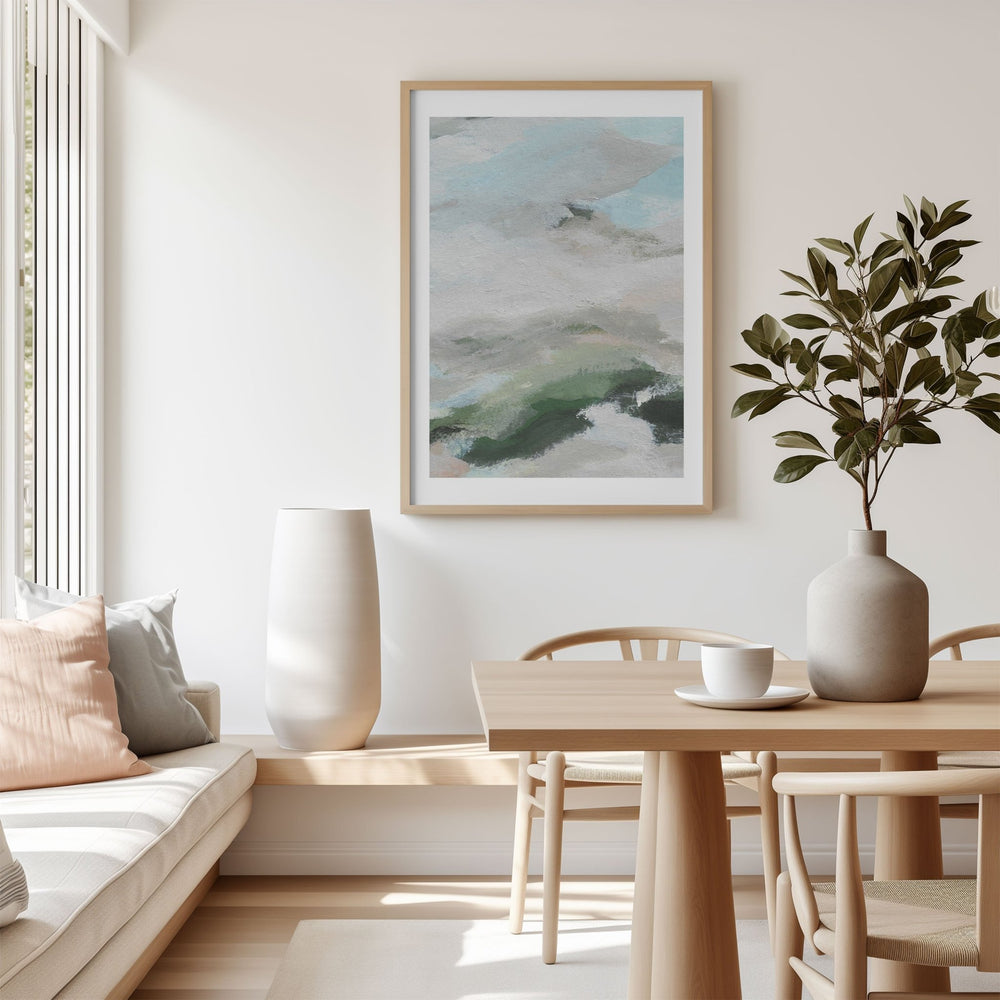 Modern living room with a painting, vase, and plant on a table.