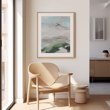 Modern interior with a beige armchair, abstract painting, and side table.