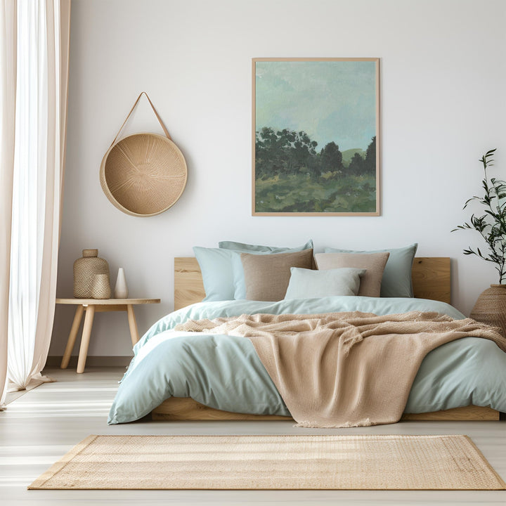 Neatly made bed with light green bedding and beige blanket in a bedroom setting.