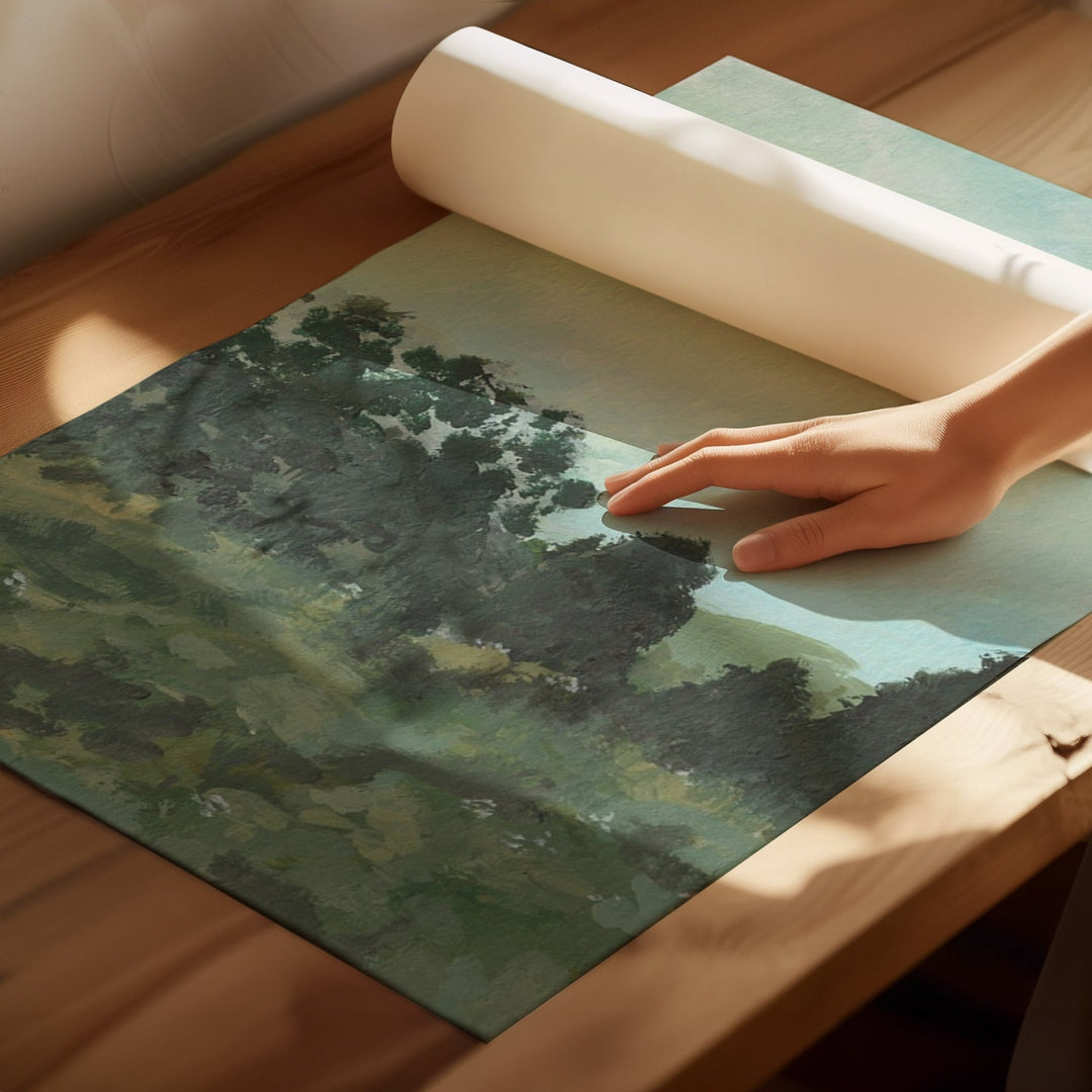 Hand rolling out a green landscape mat on a wooden surface