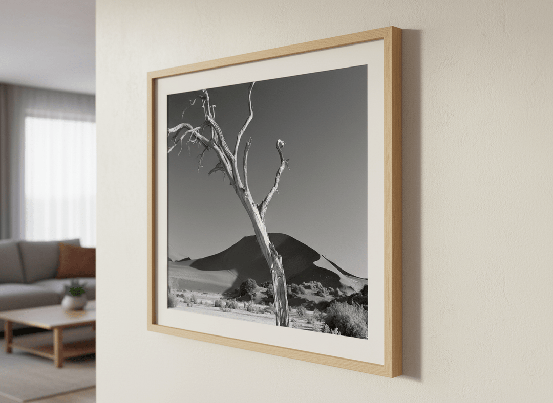 Modern wall art styled above a sofa in a neutral living room