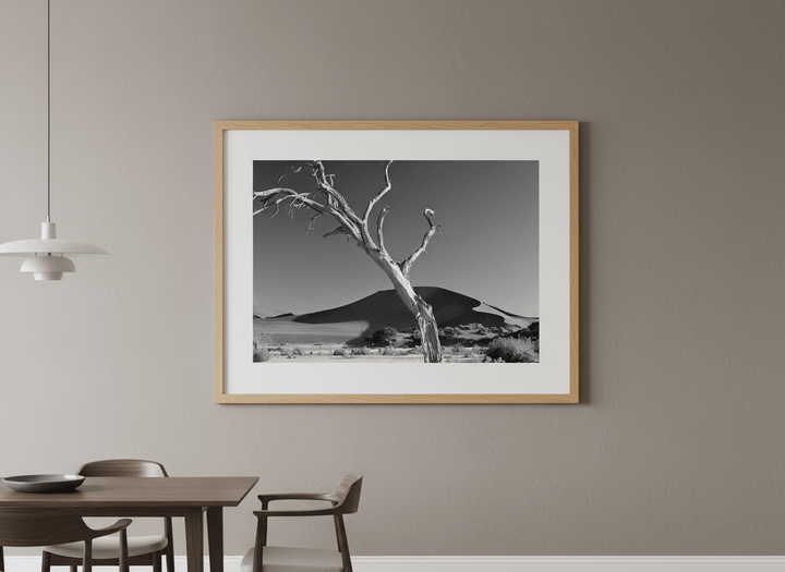 Wall art styled above a dining table in a contemporary home