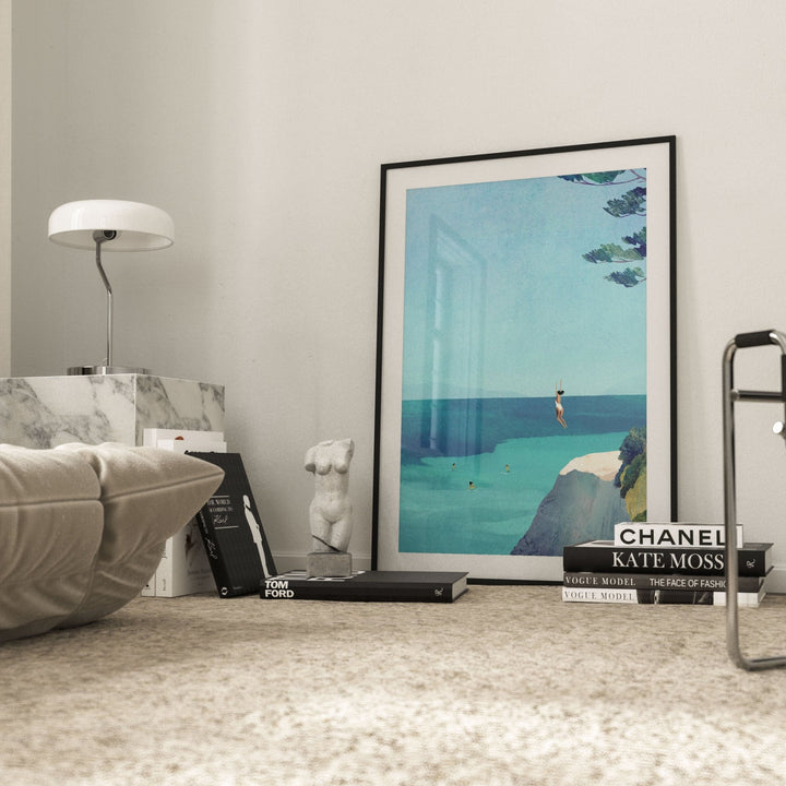 artwork on a coffee table with books and decor items in a living room setting.